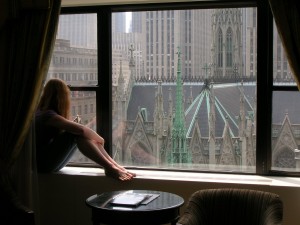 Jess looking out the hotel room window